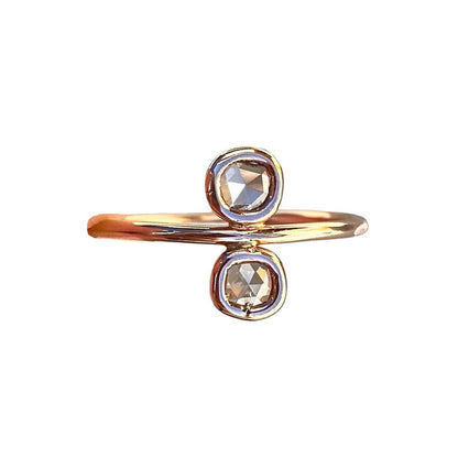 A delicate diamond slice rose gold ring by NIXIN Jewelry is displayed against a white background.