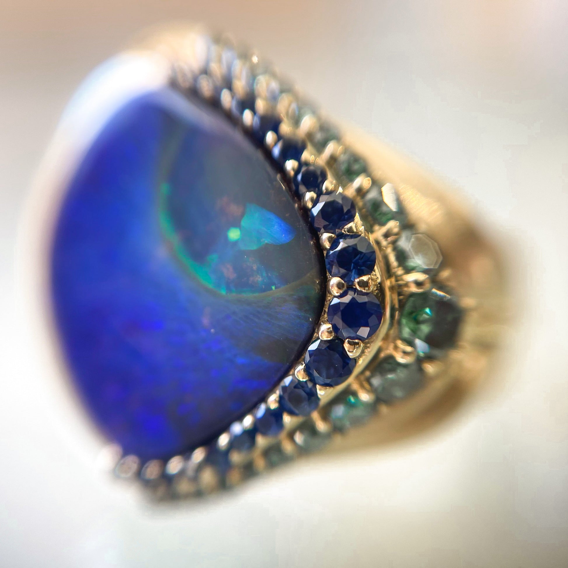 Australian Opal Ring by NIXIN Jewelry under magnification. Sapphire, Diamond and Opal ring.