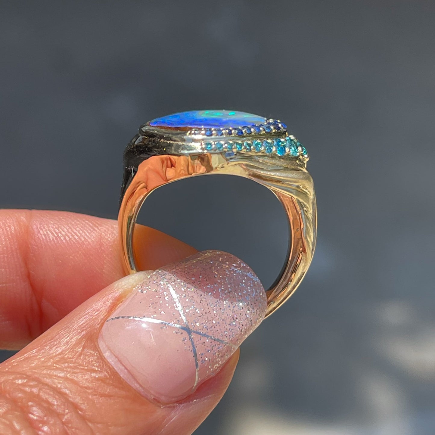 Australian Opal Ring by NIXIN Jewelry shown in profile. Sapphire and opal ring.