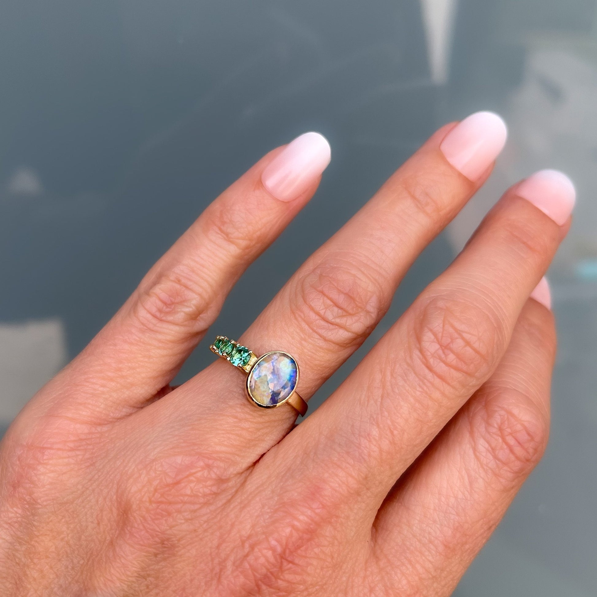 Black opal ring by NIXIN Jewelry shown on hand