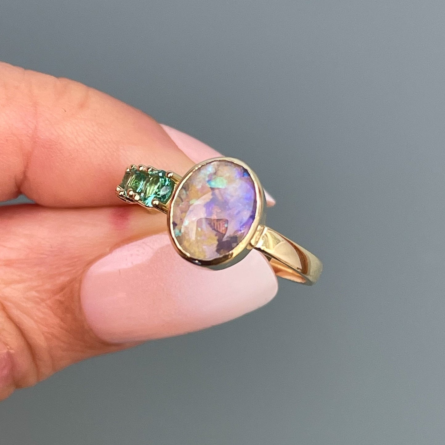 Gold opal ring by NIXIN Jewelry held in shade