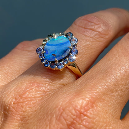 Australian Opal Ring by NIXIN Jewelry modeled on hand in sun. Shows the knife edge band under the natural opal ring.