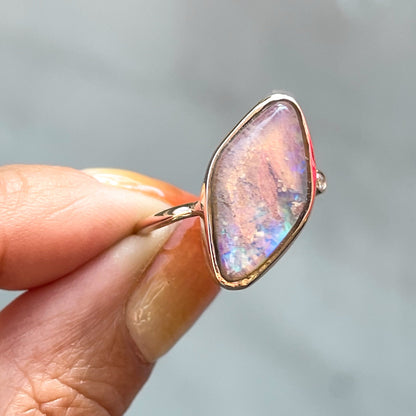 Zion Dali Australian Opal Ring by NIXIN Jewelry held in shade. Natural opal rings rose gold.