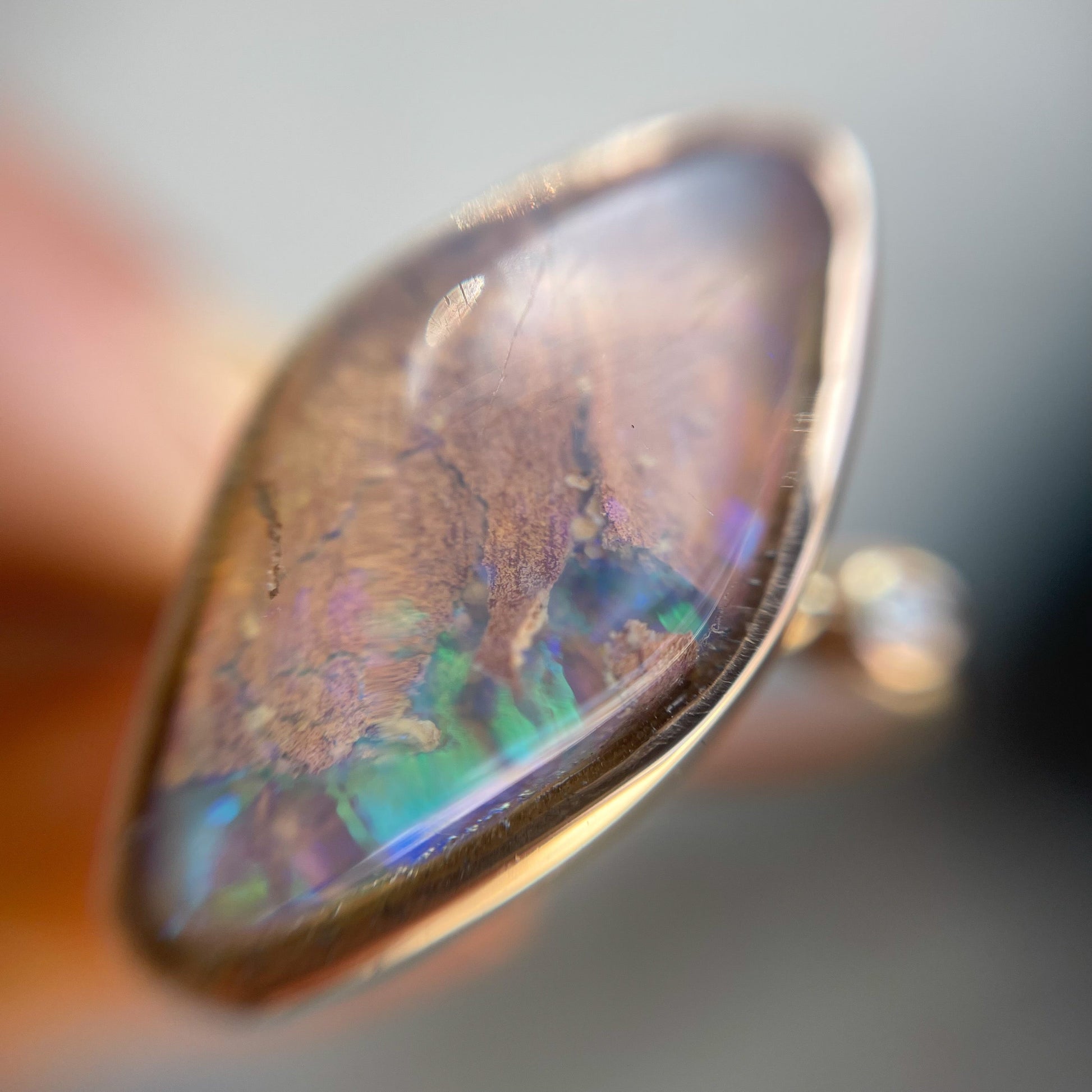 Zion Dali Australian Opal Ring by NIXIN Jewelry in the shade shot under a loupe.