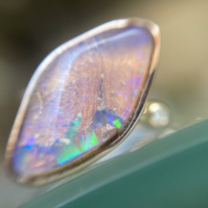 Zion Dali Australian Opal Ring by NIXIN Jewelry shown magnified and  in shade. Simple opal ring.